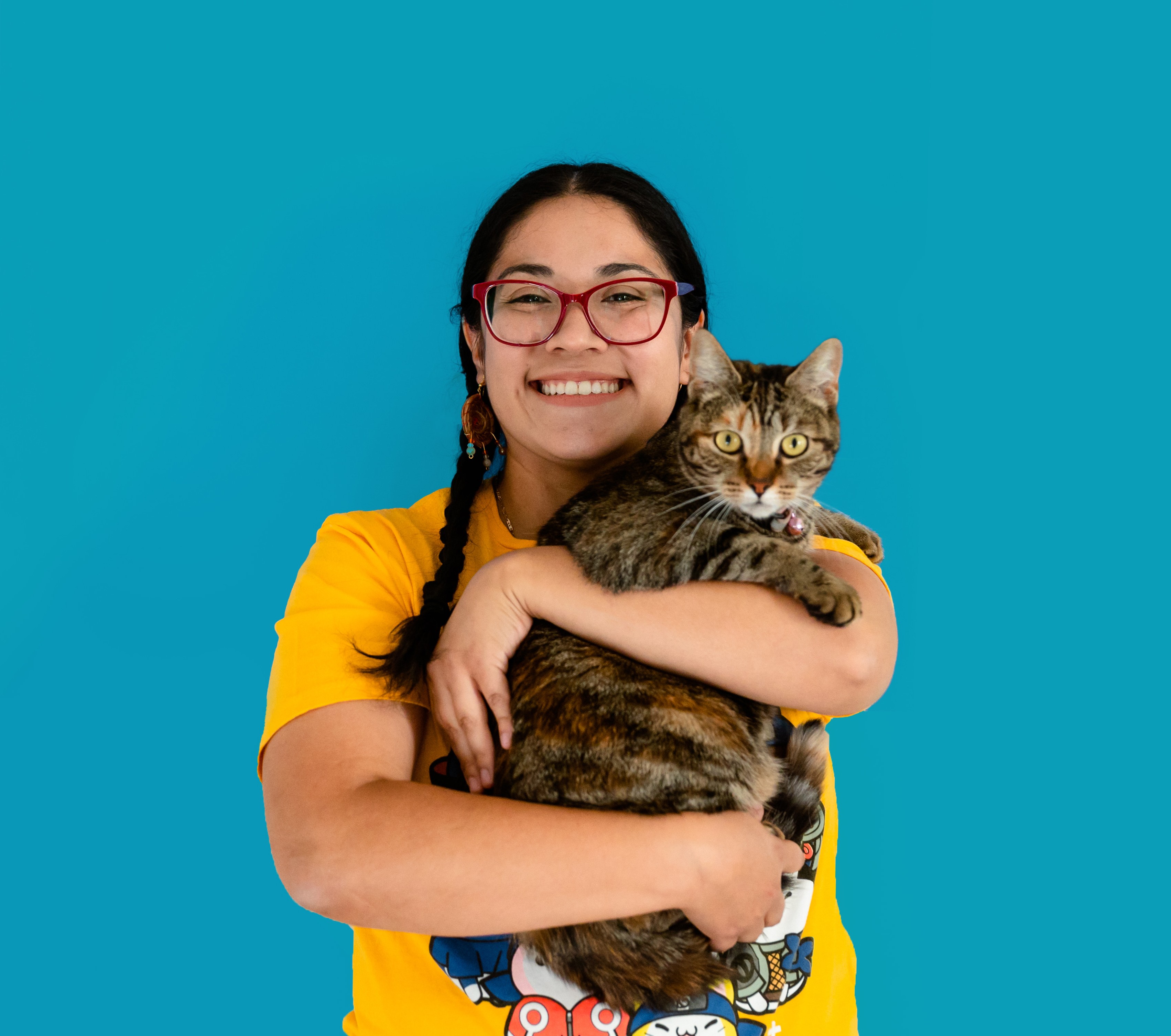 Happy cat parent holding a tabby cat