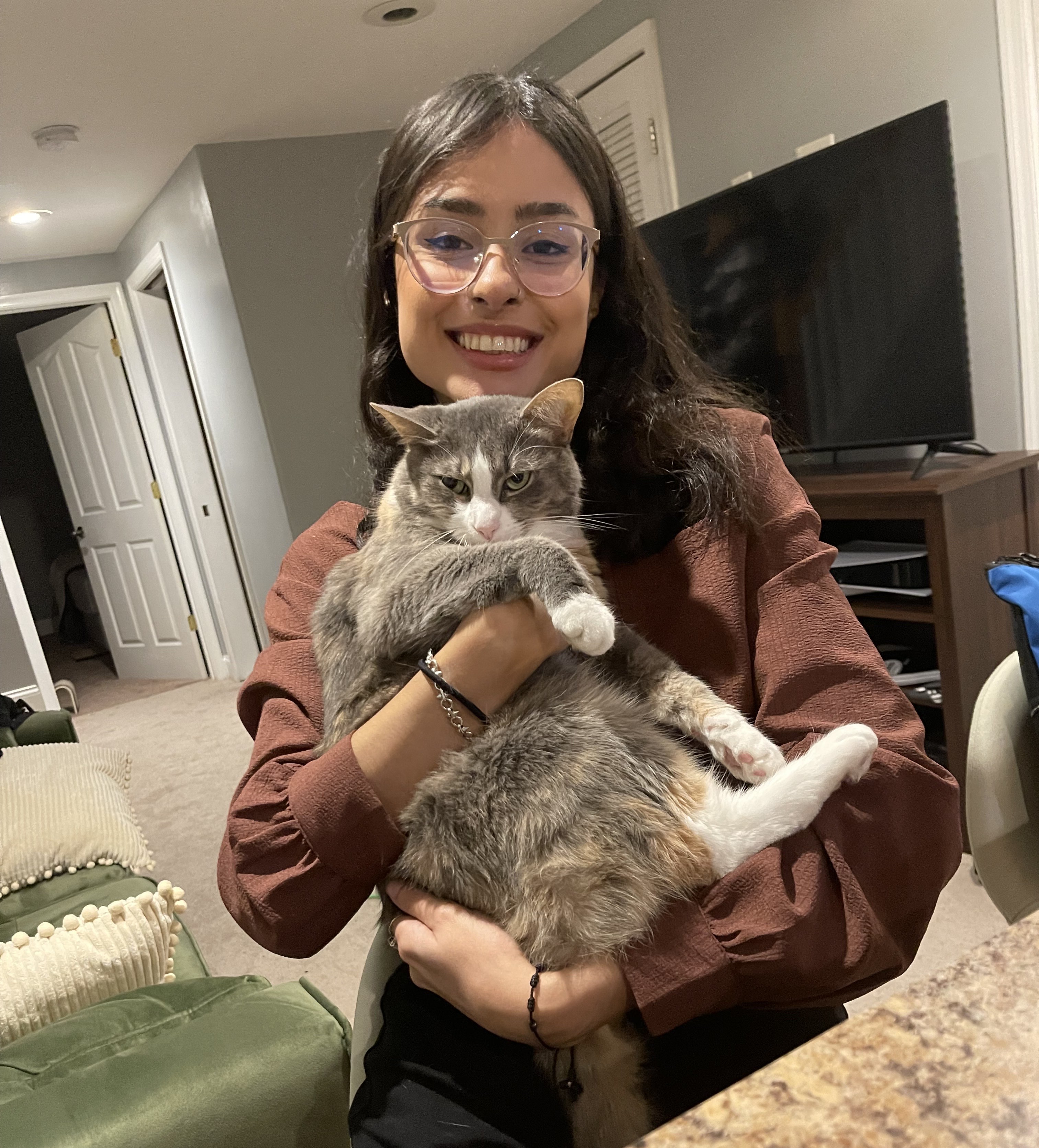 Happy cat parent holding a tabby cat