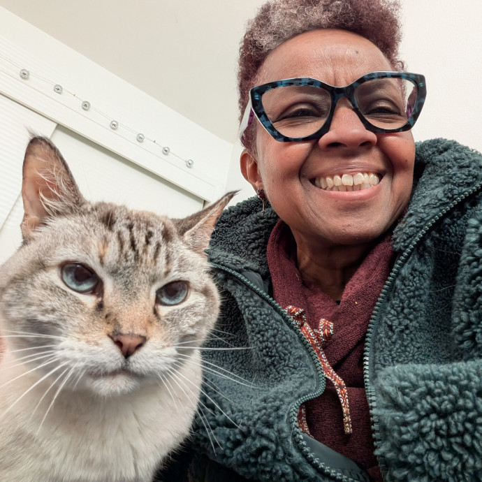 Happy cat parent holding a tabby cat