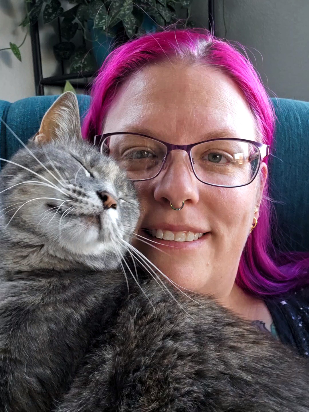 Happy cat parent holding a tabby cat
