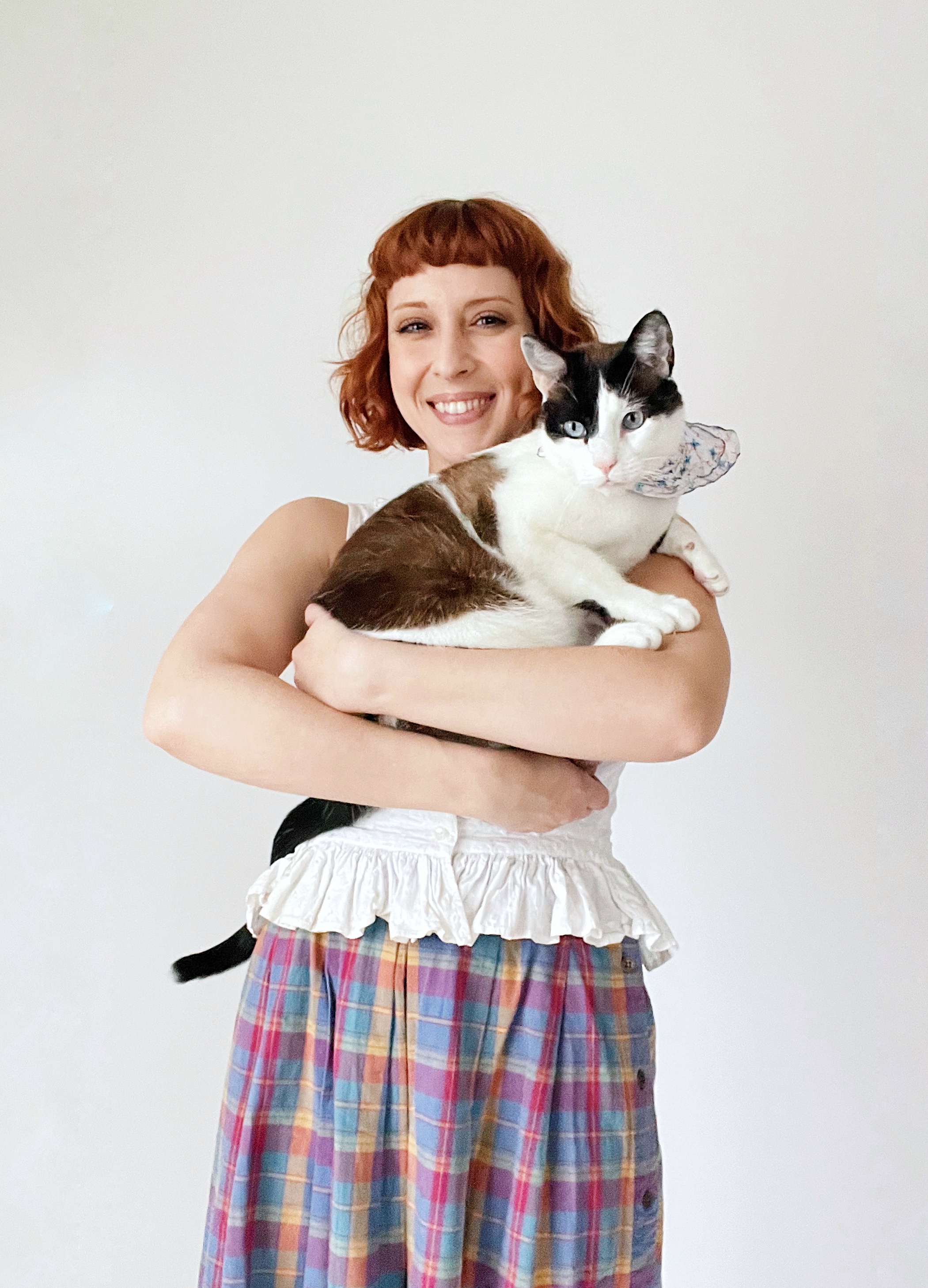 Happy cat parent holding a tabby cat